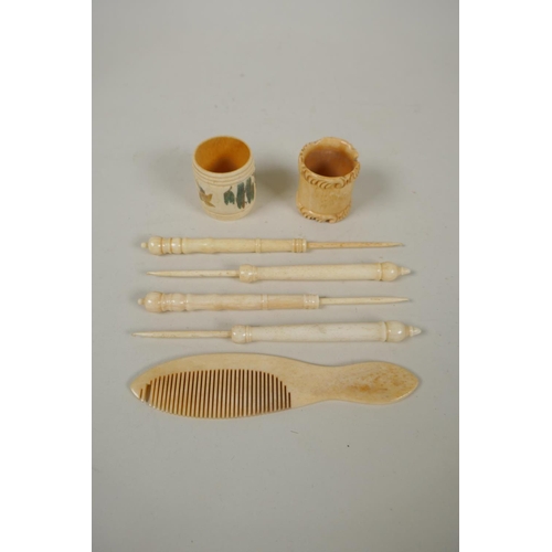 283 - A collection of antique carved bone button hooks, a comb and two napkin rings, largest 16cm long