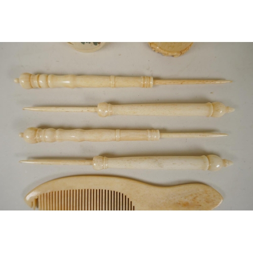 283 - A collection of antique carved bone button hooks, a comb and two napkin rings, largest 16cm long