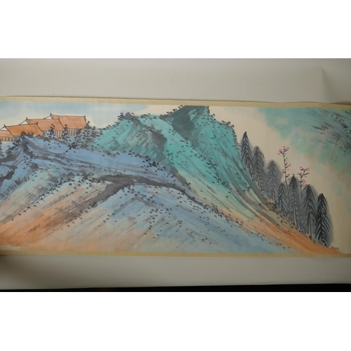 295 - A Chinese printed watercolour scroll depicting an extensive landscape scene, 34cm wide