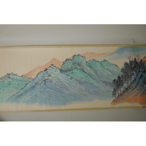 295 - A Chinese printed watercolour scroll depicting an extensive landscape scene, 34cm wide