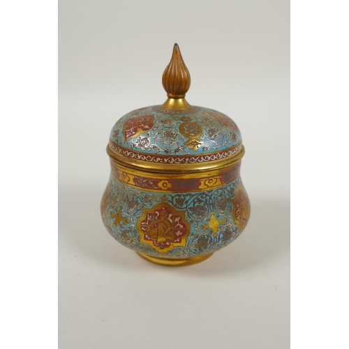 31 - An Islamic gilt brass and enamel sweet meat jar and cover, decorated with animals, figures and flowe... 