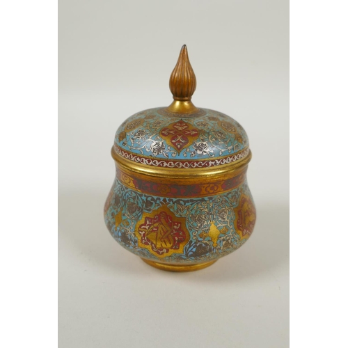 31 - An Islamic gilt brass and enamel sweet meat jar and cover, decorated with animals, figures and flowe... 