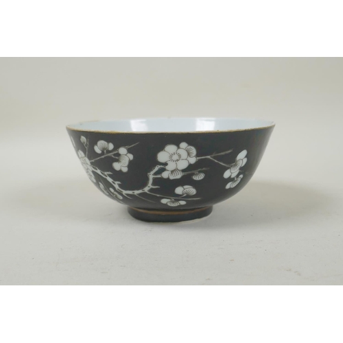 33 - A late C19th/early C20th Chinese famille noire porcelain rice bowl with prunus blossom decoration, Q... 