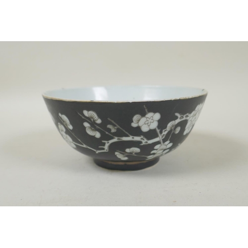 33 - A late C19th/early C20th Chinese famille noire porcelain rice bowl with prunus blossom decoration, Q... 