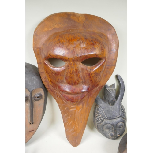 34 - A collection of tribal masks to include a Mali Marka mask, a Congolese Lega peoples mask, a Congoles... 