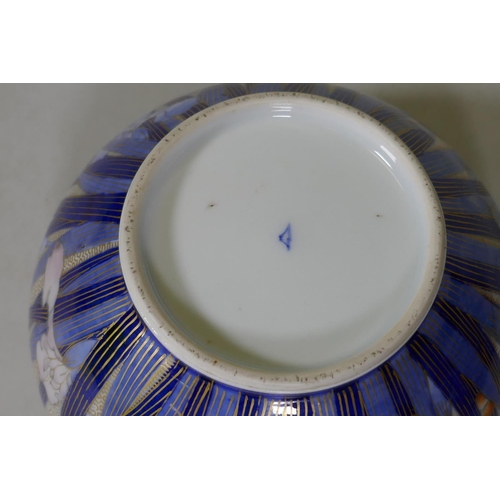 36 - A Japanese Fukagawa porcelain bowl with Iris decoration, the interior with a painted leaf over a fir... 