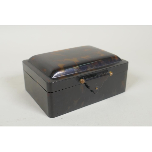 41 - An antique tortoiseshell box with cushion shaped cover, 11 x 7cm, 5cm high