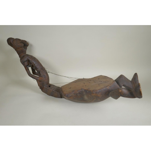 45 - An African early C20th Congolese carved wood Kundi harp with figural decoration, 68cm long