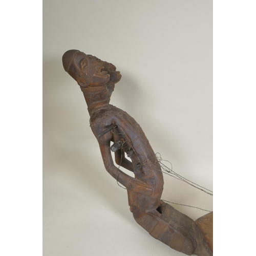 45 - An African early C20th Congolese carved wood Kundi harp with figural decoration, 68cm long