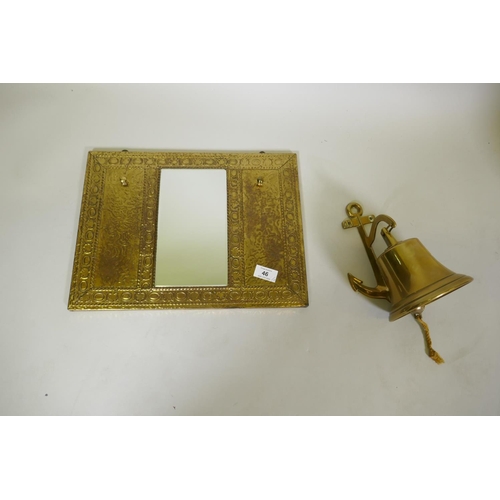 46 - A brass hall mirror with hooks and ship's bell, 22cm long