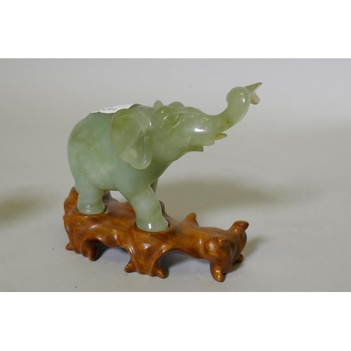 49 - An antique Chinese carved celadon jade figure of an elephant, on bespoke rootwood base, 12cm high, a... 