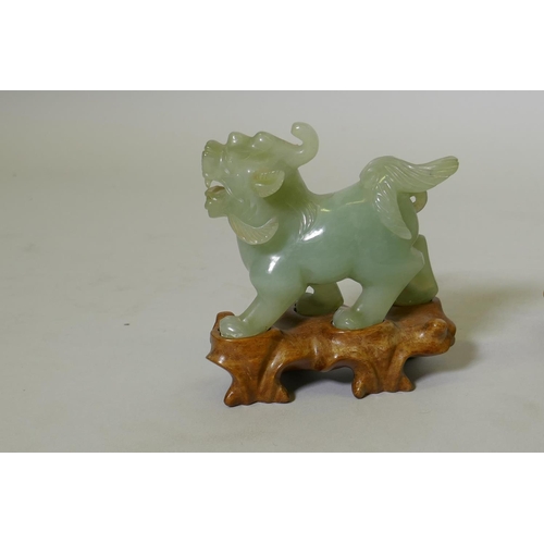 49 - An antique Chinese carved celadon jade figure of an elephant, on bespoke rootwood base, 12cm high, a... 