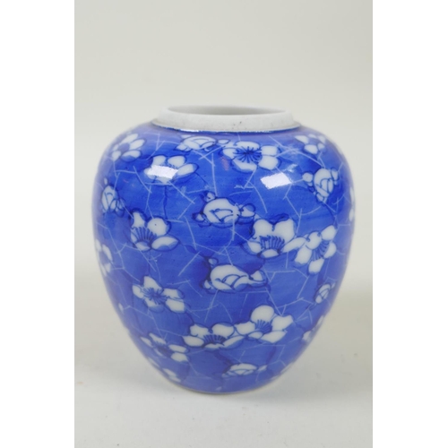 52 - A C19th Japanese Meiji period blue and white porcelain ginger jar decorated with prunus blossom on a... 