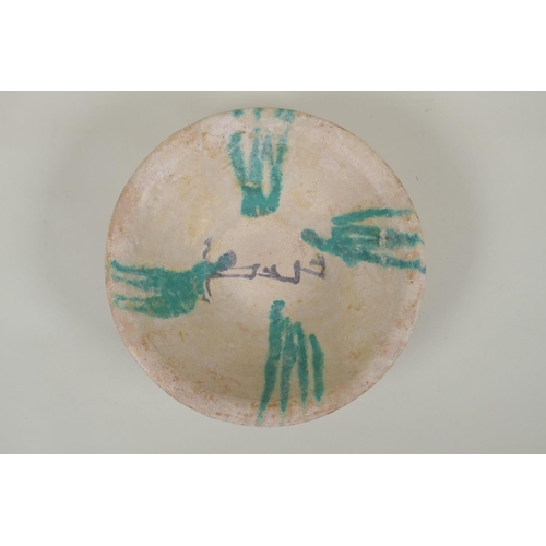 58 - An antique Islamic Abbasid pottery bowl with calligraphy inscriptions, 21cm diameter