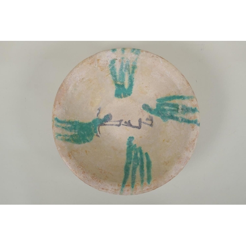 58 - An antique Islamic Abbasid pottery bowl with calligraphy inscriptions, 21cm diameter