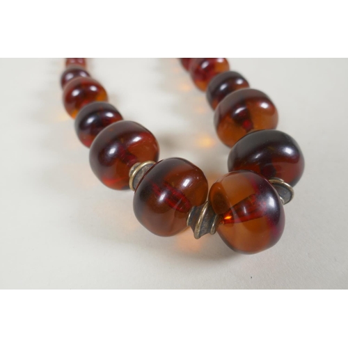 604 - A graduated honey amber bead necklace, 136g gross