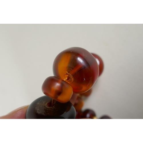 604 - A graduated honey amber bead necklace, 136g gross