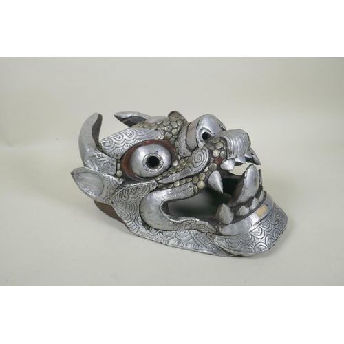 61 - A Tibetan metal mounted horned deity mask, 32cm