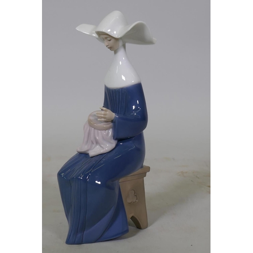 72 - A Lladro figure, 'Sewing', No.5501, 20cm high