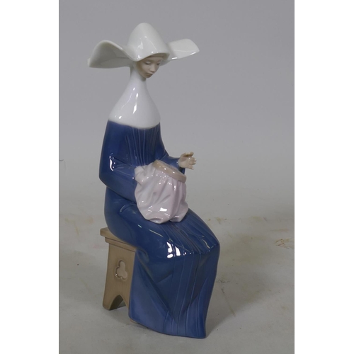 72 - A Lladro figure, 'Sewing', No.5501, 20cm high