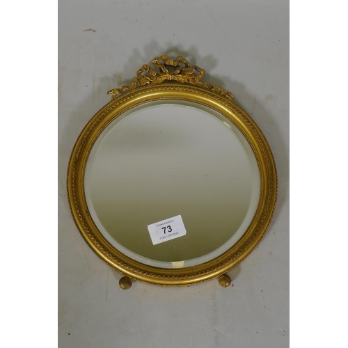 73 - An antique Empire style ormolu hanging wall mirror with bevelled glass, 28cm high