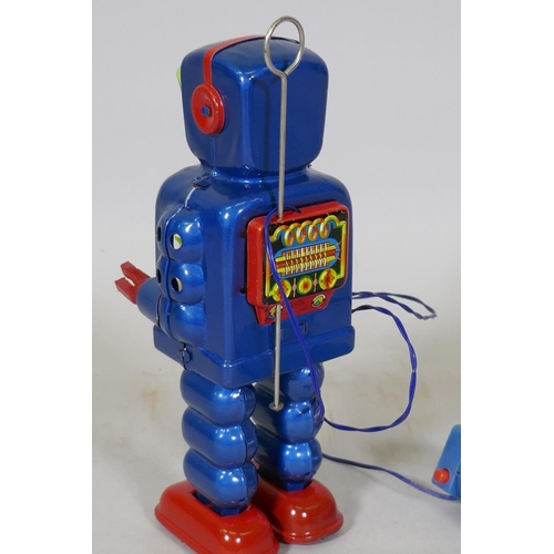 77 - A vintage Japanese battery operated tin plate robot, marked KO (Yoshiya), 23cm high