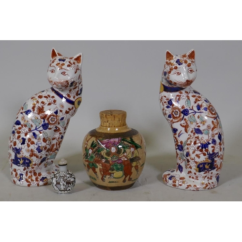 79 - A pair of Chinese ceramic cats decorated in the Imari palette, stamped to base, 26cm high, a crackle... 