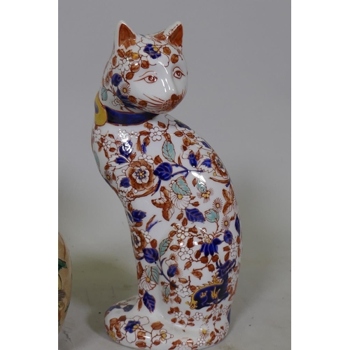 79 - A pair of Chinese ceramic cats decorated in the Imari palette, stamped to base, 26cm high, a crackle... 