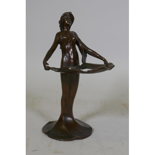 86 - An Art Nouveau style bronzed white metal card tray in the form of a woman holding lily pads, 21cm hi... 