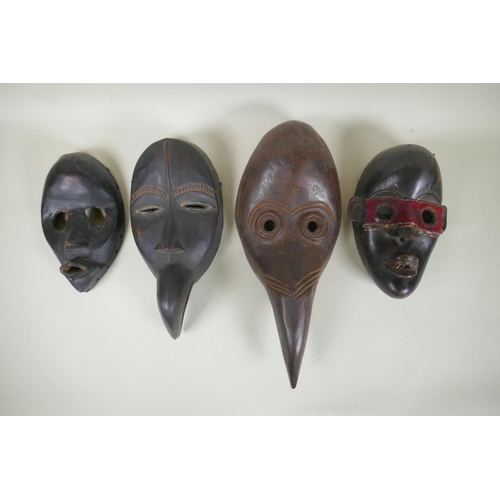 9 - Four West African Dan tribe carved wood masks, largest 38cm