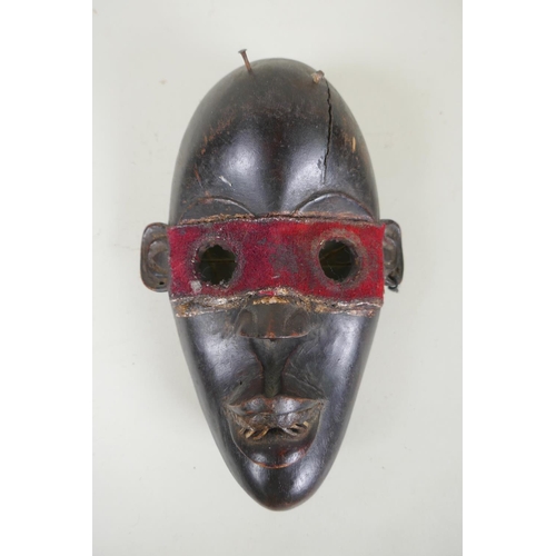 9 - Four West African Dan tribe carved wood masks, largest 38cm