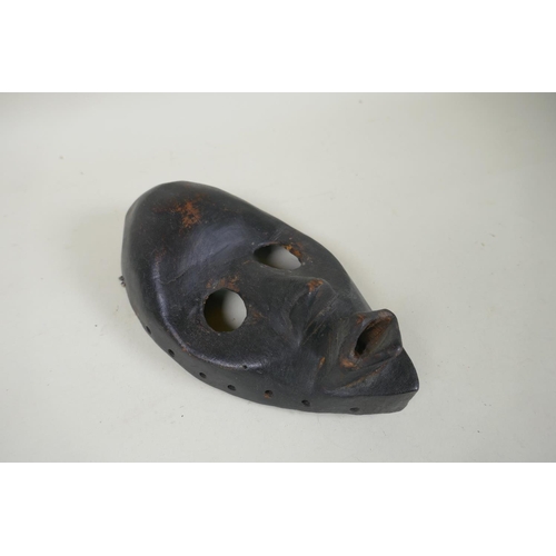 9 - Four West African Dan tribe carved wood masks, largest 38cm