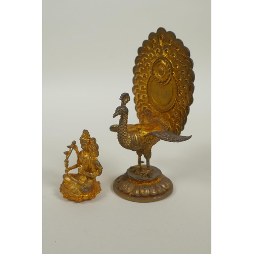 91 - A Sino Tibetan gilt bronze figure of Buddha seated on the back of a phoenix, 12cm high