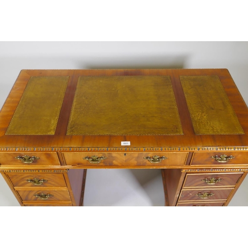 1211 - A Georgian style mahogany pedestal desk with inset leather top, six drawers and cupboard, raised on ... 