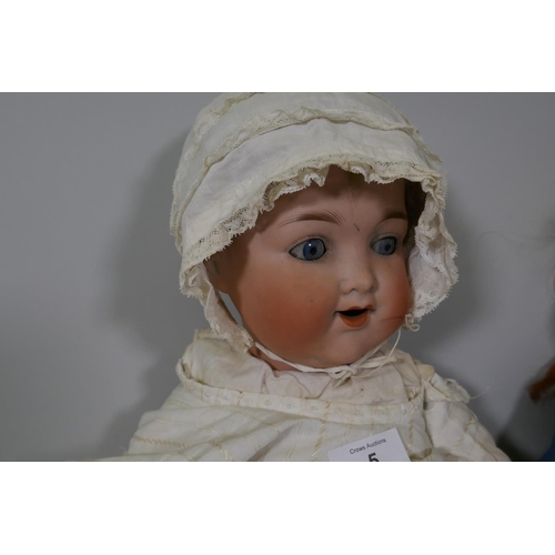 207 - Four porcelain head dolls, an Armand Marseille 991 doll with rolling eyes and open mouth, compositio... 