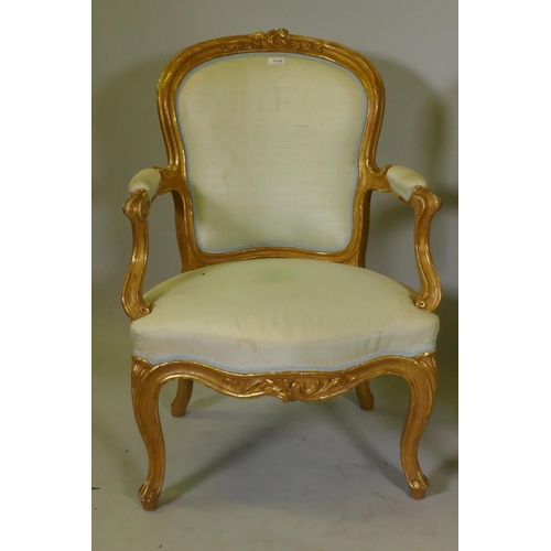 1001 - A pair of antique watergilt show frame armchairs with carved decoration and silk covers, raised on c... 