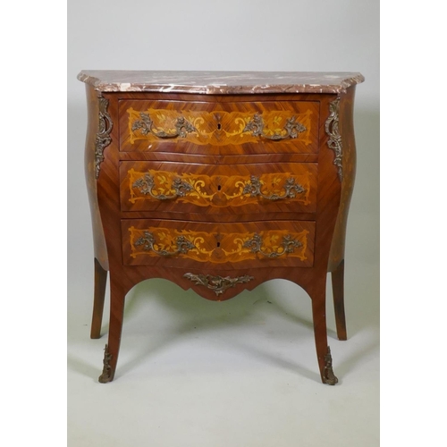 1002 - A Louis XV style marquetry inlaid serpentine front tulipwood commode with three drawers, rouge marbl... 