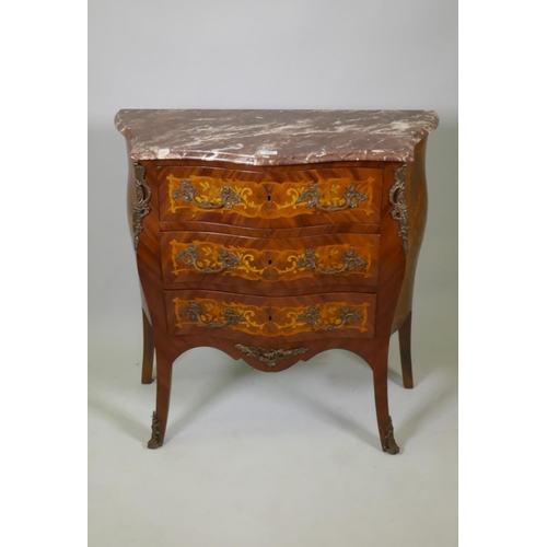 1002 - A Louis XV style marquetry inlaid serpentine front tulipwood commode with three drawers, rouge marbl... 