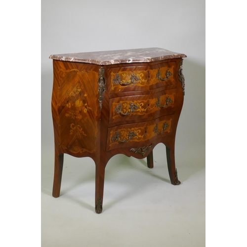 1002 - A Louis XV style marquetry inlaid serpentine front tulipwood commode with three drawers, rouge marbl... 