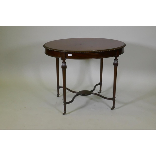 1007 - A C19th mahogany oval shaped occasional table in the manner of Gillows, with gadrooned edge and cros... 