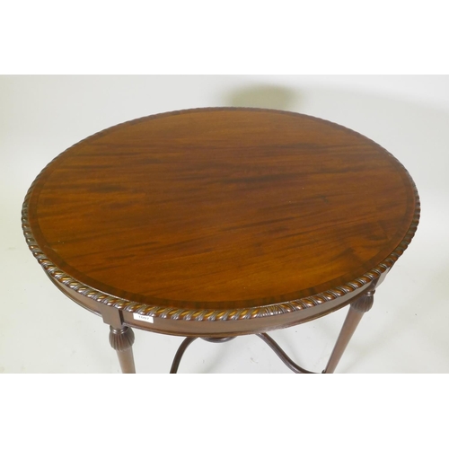 1007 - A C19th mahogany oval shaped occasional table in the manner of Gillows, with gadrooned edge and cros... 