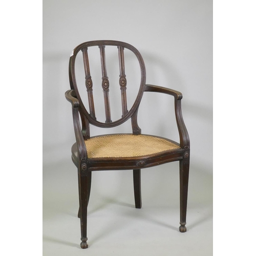 1013 - A walnut Adam style elbow chair, with carved paterae and bead decoration, and serpentine front, rais... 