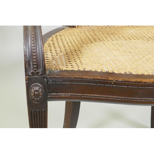 1013 - A walnut Adam style elbow chair, with carved paterae and bead decoration, and serpentine front, rais... 