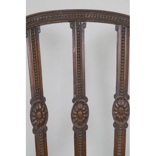 1013 - A walnut Adam style elbow chair, with carved paterae and bead decoration, and serpentine front, rais... 