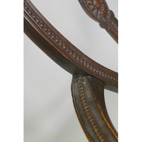 1013 - A walnut Adam style elbow chair, with carved paterae and bead decoration, and serpentine front, rais... 