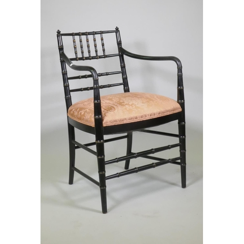 1014 - A William Morris style ebonised elbow chair with faux bamboo turned decoration