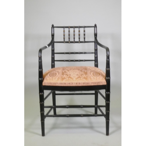 1014 - A William Morris style ebonised elbow chair with faux bamboo turned decoration