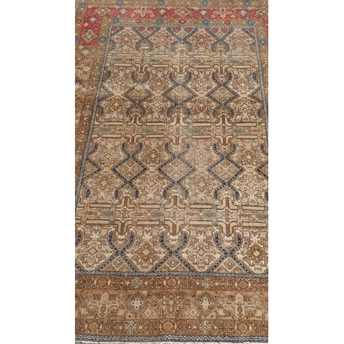 1015 - A Persian gold ground woven carpet with geometric design in blue, 187 x 132cm