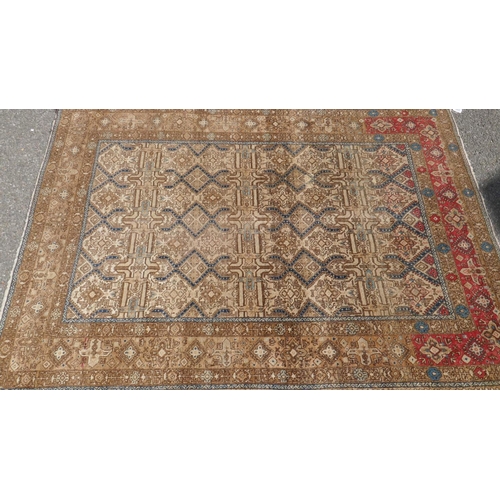 1015 - A Persian gold ground woven carpet with geometric design in blue, 187 x 132cm