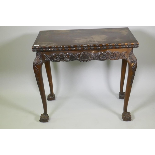 1018 - Chippendale style card table with fold over top and carved decoration, raised on cabriole supports w... 